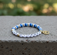 Load image into Gallery viewer, Bracelet with 'THE CITADEL' on a concrete surface with a blurred green background
