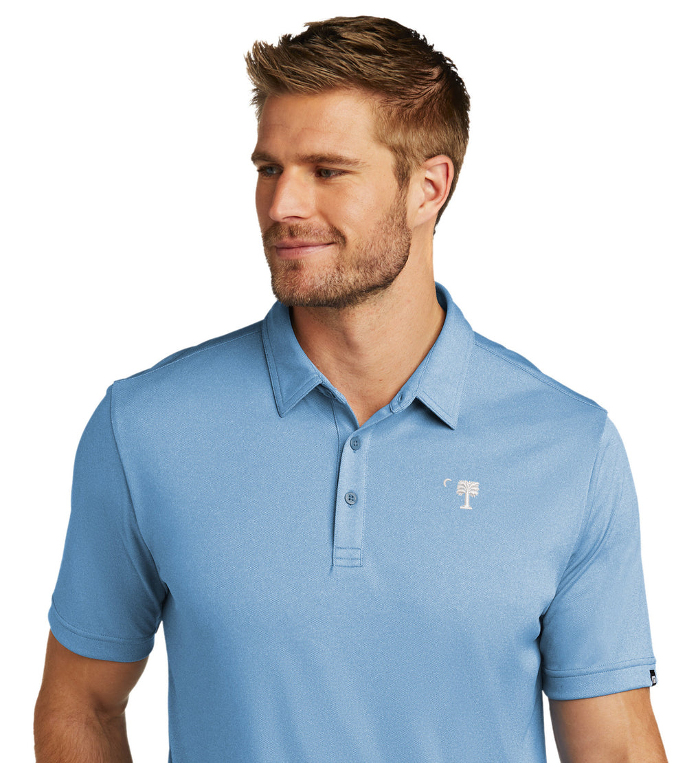 Big Red Palmetto TravisMathew Performance Polo-Brilliant Blue Heather